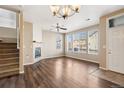 Bright and airy living room showcasing hardwood floors, a fireplace, and large windows with neighborhood views at 16149 E Geddes Ln # 99, Aurora, CO 80016