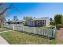 Quaint home with a welcoming front yard and classic white picket fence for added curb appeal at 1716 Fulton St, Aurora, CO 80010