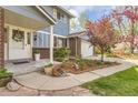 Inviting front porch with seasonal foliage and brick and siding exterior details at 4707 Ashfield Ct, Boulder, CO 80301