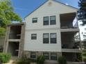 Exterior of a condo building, featuring a covered entryway, private balconies, and classic architectural details at 6705 S Field St # 802, Littleton, CO 80128