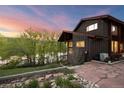 Home exterior showing a well-kept brown home and a serene water view at 3900 Bogey Ct, Longmont, CO 80503
