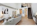 Open living area with hardwood floors and loft access at 3195 Blake St # 201, Denver, CO 80205