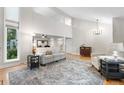 Spacious living room featuring soaring ceilings, large windows, hardwood floors, and elegant furniture at 8535 E Otero Cir, Centennial, CO 80112