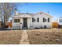 Cozy single-Gathering home featuring a welcoming front porch and well-kept landscaping at 1812 S Hazel Ct, Denver, CO 80219