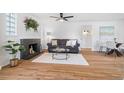 Inviting living room featuring a fireplace, hardwood floors, and abundant natural light at 1812 S Hazel Ct, Denver, CO 80219