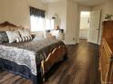 Ornately decorated bedroom with wood floors, matching furniture, and access to bath at 21924 E Lake Ave, Aurora, CO 80015