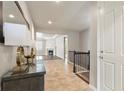 Inviting entryway with tile flooring, modern decor, and views into the bright living spaces at 4545 Oxbow Dr, Brighton, CO 80601