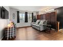 Cozy living room features wood floors, lots of natural light, and stylish decor at 12603 E Ohio Ave, Aurora, CO 80012