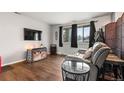 Comfortable living space features wood floors, natural light and a gray sofa at 12603 E Ohio Ave, Aurora, CO 80012