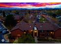 Aerial view of a well-maintained neighborhood at sunset, showcasing stunning mountain views in the distance at 7080 W 20Th Ave # 202, Lakewood, CO 80214