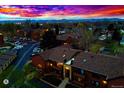 Exterior view of townhomes with parking and a colorful skyline at 7080 W 20Th Ave # 202, Lakewood, CO 80214