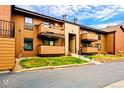 Exterior shot of townhome featuring balconies and front lawn at 7080 W 20Th Ave # 202, Lakewood, CO 80214