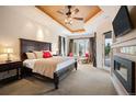 Luxurious main bedroom with a fireplace, sitting area, detailed ceiling, and natural light at 2117 S Juniper St, Lakewood, CO 80228