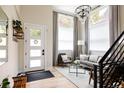 Bright foyer with hardwood floors, modern chandelier, and staircase leading to the second floor at 619 S High St, Denver, CO 80209