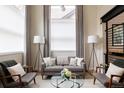 Living room featuring large windows with curtains, modern lighting and sleek, comfortable seating at 619 S High St, Denver, CO 80209