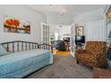Cozy bedroom transitions to living room through french doors, features art and neutral color palette at 2670 E 136Th Pl, Thornton, CO 80602