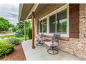 Inviting front porch featuring comfortable seating and a view of the landscaped front yard at 8588 S Woody Way, Highlands Ranch, CO 80126