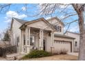 Charming two-story home featuring a welcoming front porch and attached two-car garage at 3596 S Jebel Cir, Aurora, CO 80013