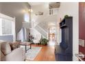 Bright living room with hardwood floors, high ceilings, and a staircase leading to upper level at 3596 S Jebel Cir, Aurora, CO 80013