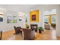 Cozy living room with a fireplace, bright colors, and warm hardwood flooring at 474 W Spruce St, Louisville, CO 80027