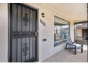 Inviting front entrance featuring security door, house number, and a cozy chair near the large window at 1380 S Fillmore St, Denver, CO 80210
