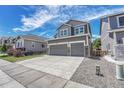 Attractive home featuring gray siding, a two-car garage, and a well-maintained driveway at 10887 Endeavor Dr, Parker, CO 80134