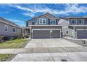 Gray home with a two-car garage and a neatly landscaped front yard at 10887 Endeavor Dr, Parker, CO 80134