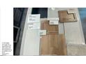 Selection of interior finishes including flooring, tiles, and cabinet samples for a cohesive home design at 8277 S Quail St, Littleton, CO 80127