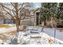 Attractive gray home featuring stone accents leading to the front entrance with landscaped yard at 364 Willowick Cir, Highlands Ranch, CO 80129