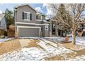 Beautiful two-story gray home showcasing an attached two-car garage and tasteful exterior design elements at 364 Willowick Cir, Highlands Ranch, CO 80129