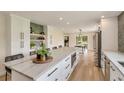 Spacious kitchen island with seating, ample storage, and stainless steel appliances at 15545 Lipan St, Broomfield, CO 80023