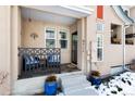 Front porch with seating area, blue pots, and a black metal railing at 9711 W Indore Dr, Littleton, CO 80128