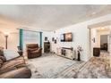 Spacious living room with plush seating, decorative accents and wood-look flooring at 7695 E Quincy Ave # 105, Denver, CO 80237