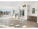 Bright living room with fireplace, hardwood floors, and sliding glass doors to the deck at 5392 Lions Paw St, Castle Rock, CO 80104