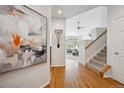 Bright foyer with hardwood floors and stairway leading to the upper level at 12860 E Dickensen Pl, Aurora, CO 80014