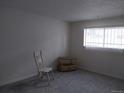 Cozy bedroom featuring neutral paint and a bright window at 10211 Ura Ln # 101, Thornton, CO 80260
