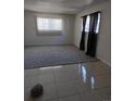 The living room offers a spacious layout with neutral carpeting at 10211 Ura Ln # 101, Thornton, CO 80260