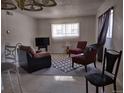 Inviting living room with large window providing natural light at 10211 Ura Ln # 101, Thornton, CO 80260