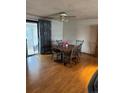 Inviting dining area featuring hardwood floors and a sliding glass door leading to an outdoor space at 8278 Cherokee St, Denver, CO 80221