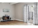 Bright living room with a fireplace and sliding glass doors leading to the outside at 9700 E Iliff Ave # 81, Denver, CO 80231