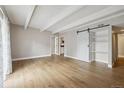 Bright living room showcasing open design, light wood floors, and modern sliding door at 9700 E Iliff Ave # 81, Denver, CO 80231