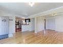 Open concept living area with hardwood floors flows into a modern kitchen at 11085 Clarkson St, Northglenn, CO 80233