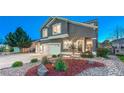 Beautiful two-story home with a well-manicured lawn and mature trees at 17050 Park Trail Dr, Monument, CO 80132
