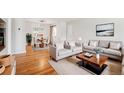 Bright living room with hardwood floors, neutral decor, and a separate dining area, creating an inviting and open space at 2777 S Adams St, Denver, CO 80210