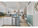 Beautiful kitchen featuring white cabinets, stainless steel appliances, and access to the living room at 8773 W Cornell Ave # 10, Lakewood, CO 80227