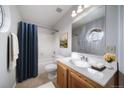 Cozy bathroom features a shower-tub combo and charming round window at 8621 E Dry Creek Rd # 325, Englewood, CO 80112