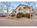 Townhome with a private balcony, attached garage, and well-manicured landscaping at 8621 E Dry Creek Rd # 325, Englewood, CO 80112
