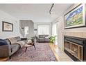 Inviting living room with a fireplace, hardwood floors, and two sofas at 10290 W Jewell Ave # B, Lakewood, CO 80232