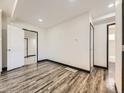 Spacious living area featuring hardwood floors and neutral paint, leading to other rooms at 655 S Osceola St, Denver, CO 80219