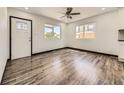Bright living room featuring hardwood floors, large windows, and an open concept design at 655 S Osceola St, Denver, CO 80219